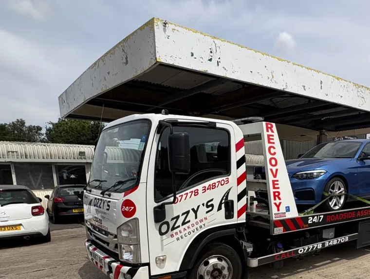 Blue coupe on the Ozzy’s Breakdown Recovery truck